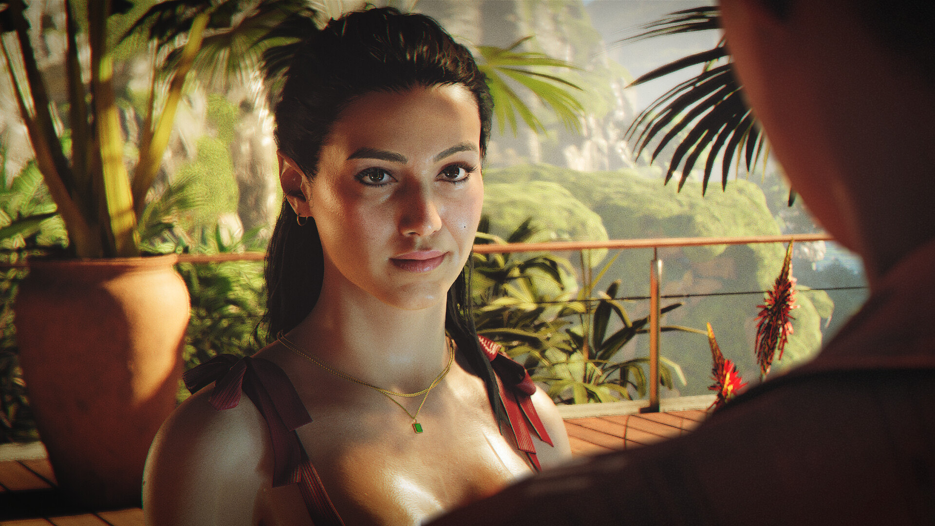 A woman on a sunlit tropical terrace during a conversation in 007 First Light.